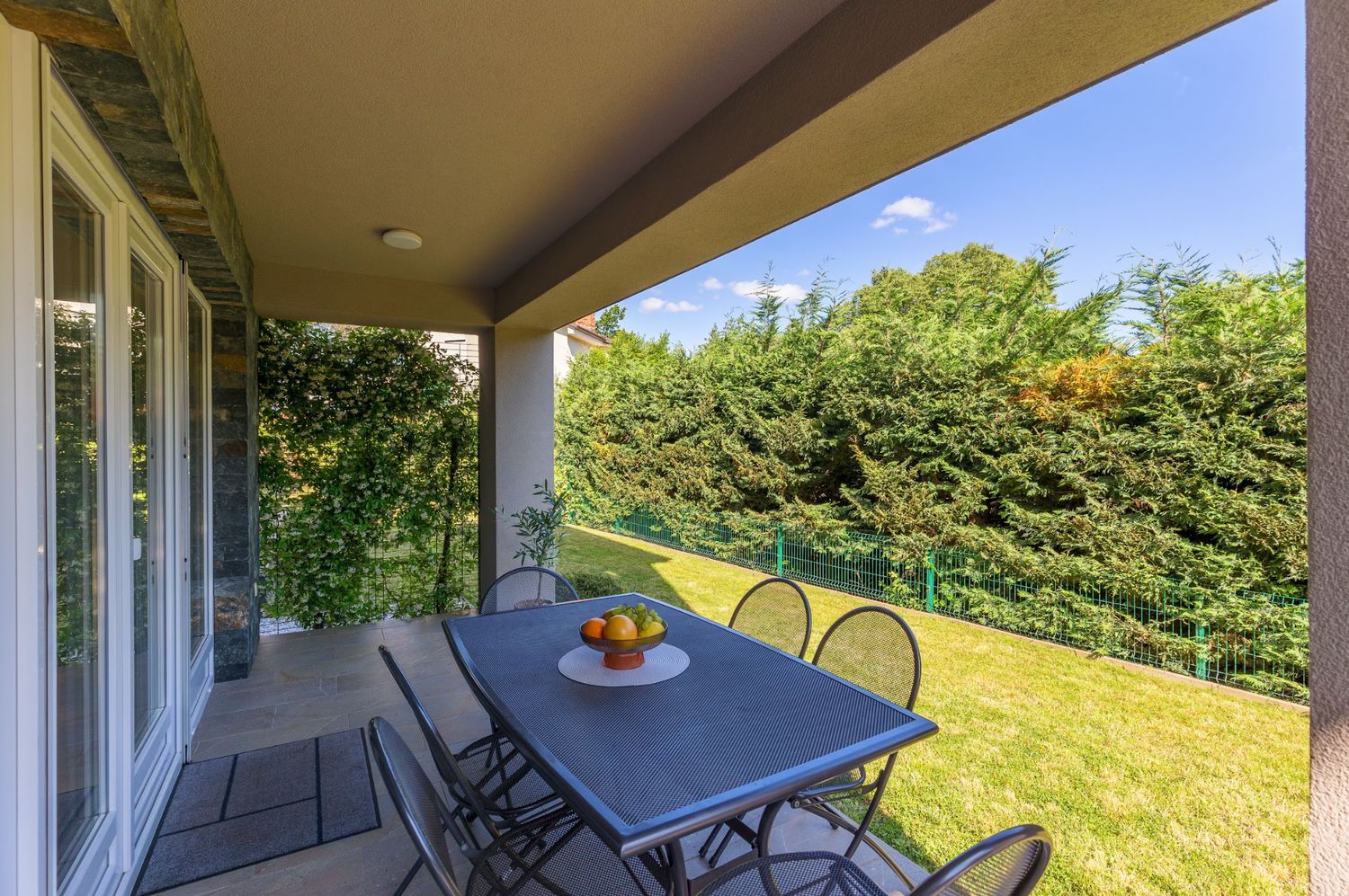 Apartment 2 covered terrace opening onto its private lawn